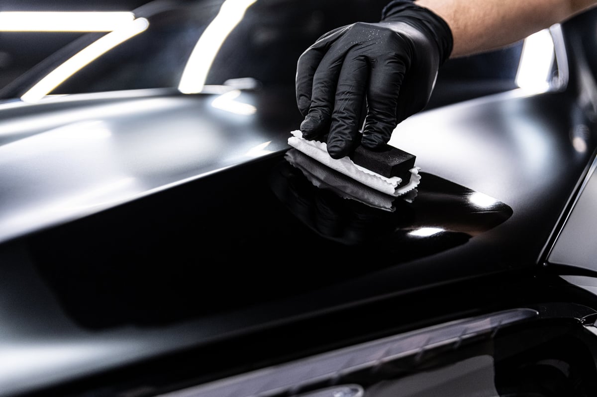 Professional ceramic coating application on black car paint in Greensboro NC - providing deep gloss and long-lasting paint protection