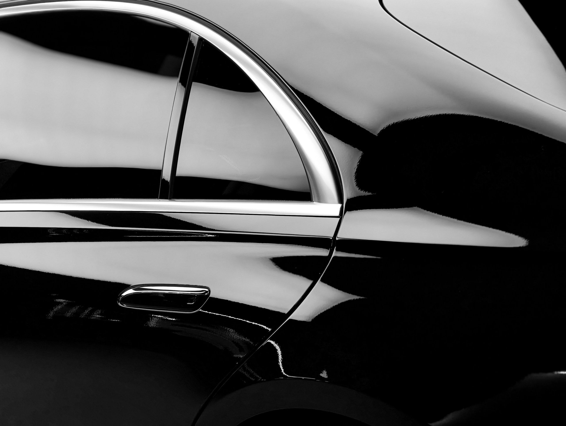Polished luxury vehicle reflecting light with elegant curves and chrome accents